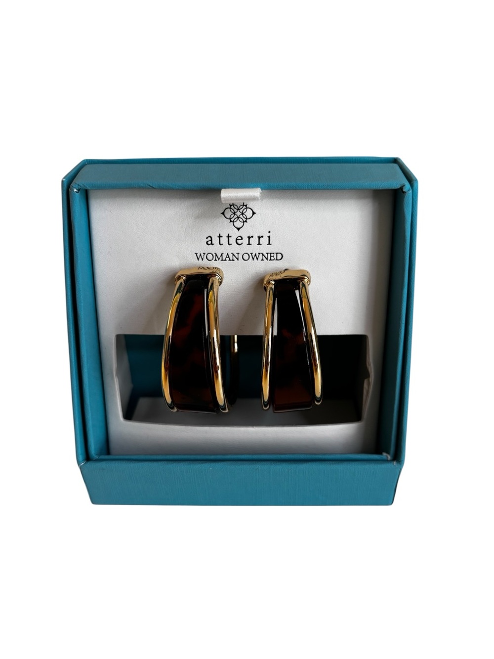 Atterri wide split tortoise shell hoops outlined with gold tone metal bands.